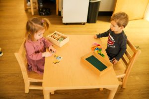 A student using Montessori number rods to understand counting and measurement.