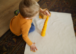 A child preparing a snack as part of Montessori practical life activities, fostering independence.