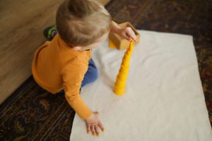 A child preparing a snack as part of Montessori practical life activities, fostering independence.