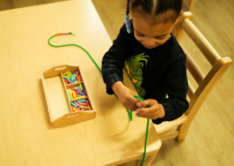 Montessori classroom where students are focused on self-paced learning with sensory materials.