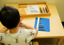 Children developing fine motor skills through Montessori lacing and threading activities.