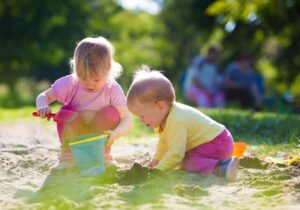 Children developing fine motor skills through Montessori lacing and threading activities.