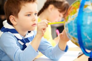 Montessori practical life area where children learn to care for their environment by watering plants.