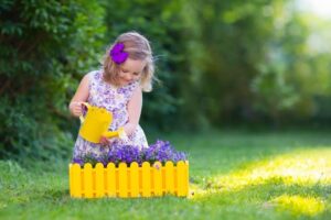 A child working independently with Montessori pink tower cubes to develop spatial awareness.