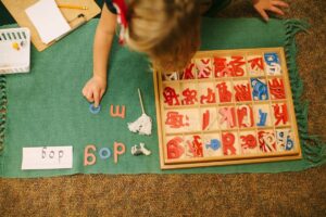 Students learning about geography with Montessori continent maps and flags.
