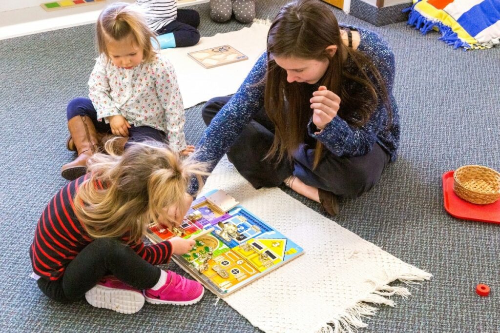 Children practicing Montessori math using bead chains to learn multiplication.